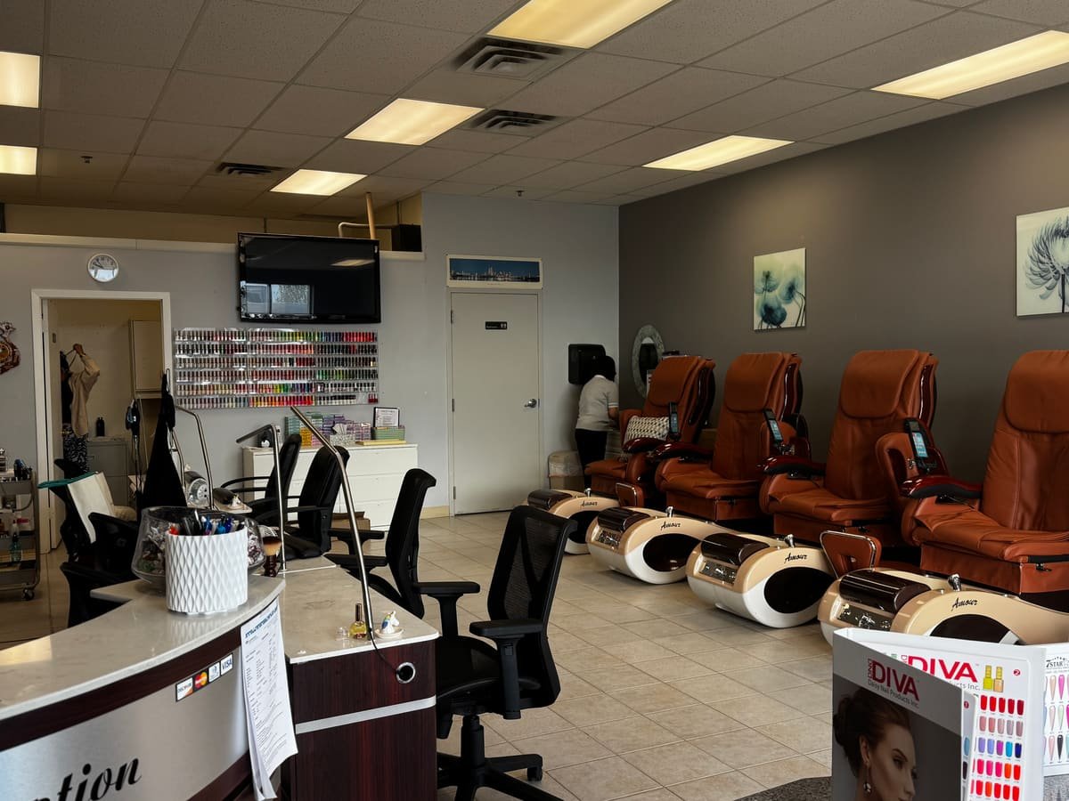 Bright, clean salon floor with pedicure chairs and manicure stations at Great Nails