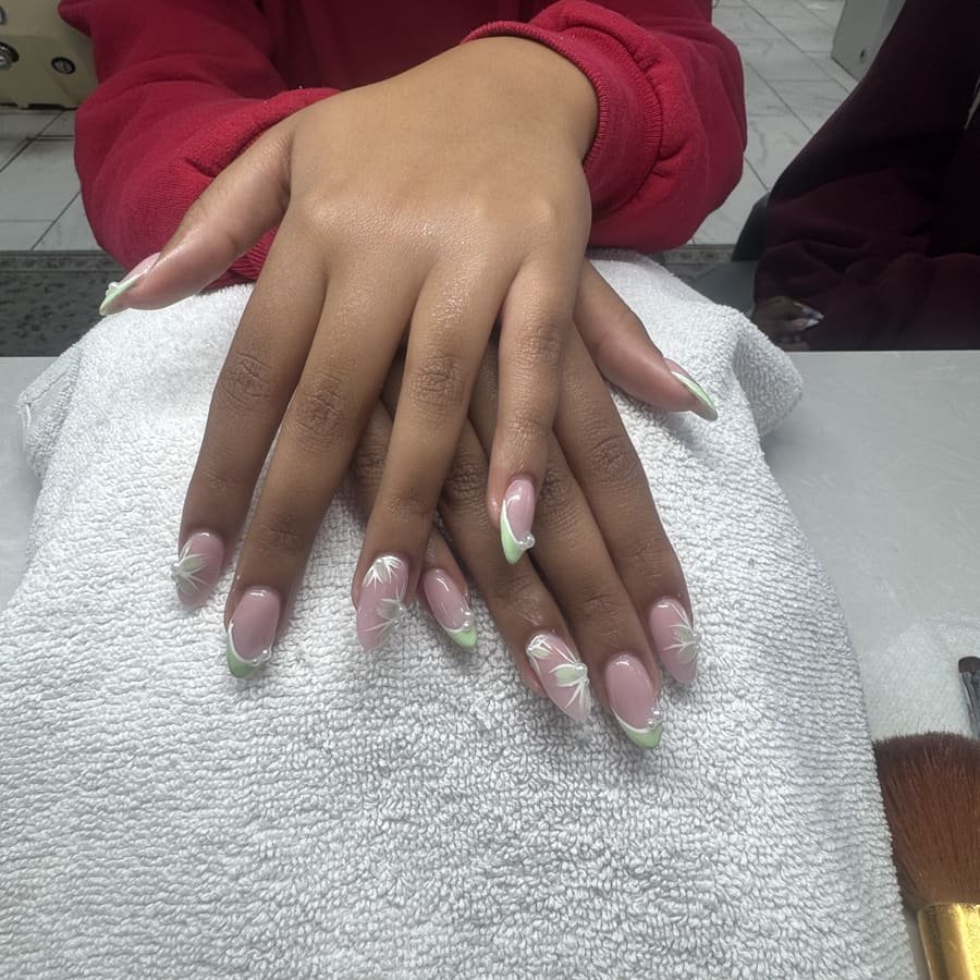 Almond nails with green and white swirl French tips