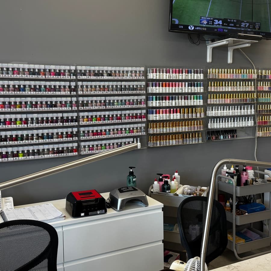 Manicure station with gel lamps in front of the polish racks