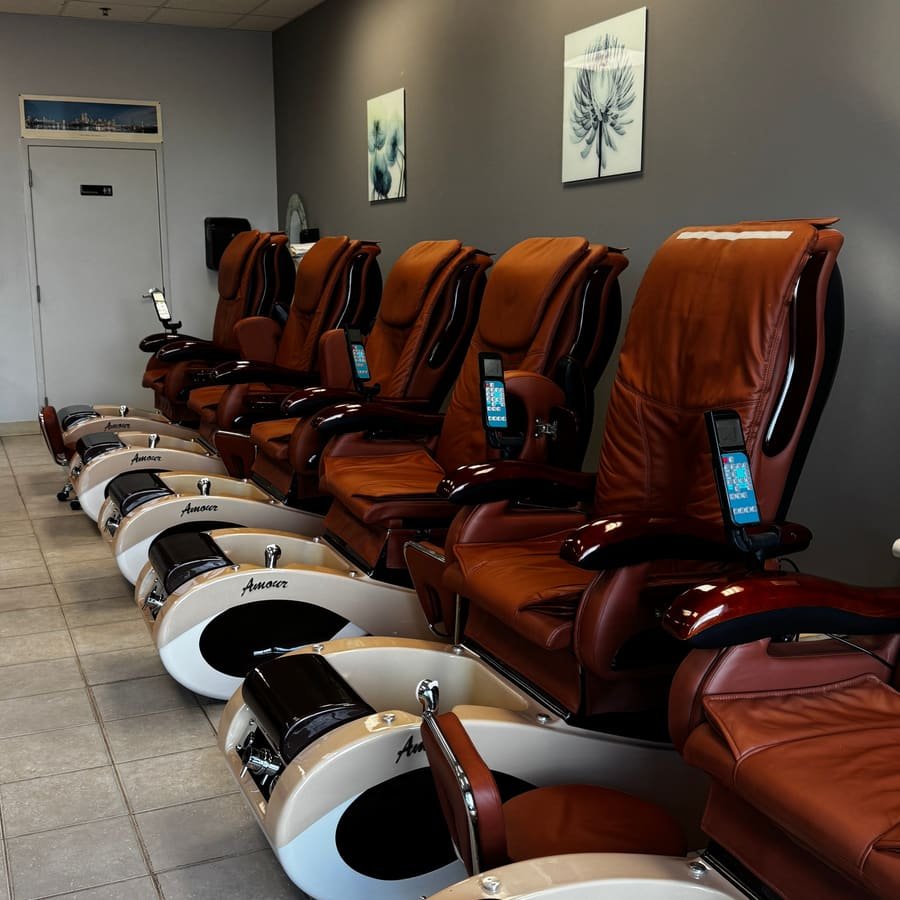 Row of pedicure spa chairs at Great Nails
