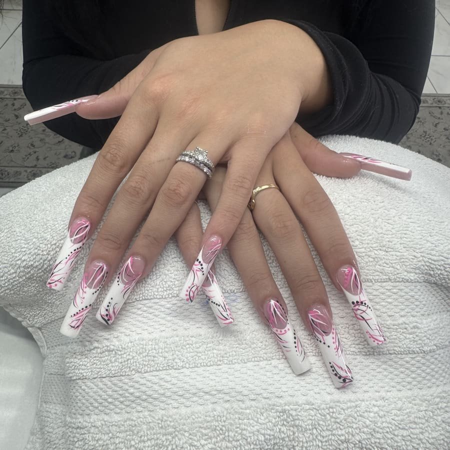 Long pink and white nails with hand-painted nail art