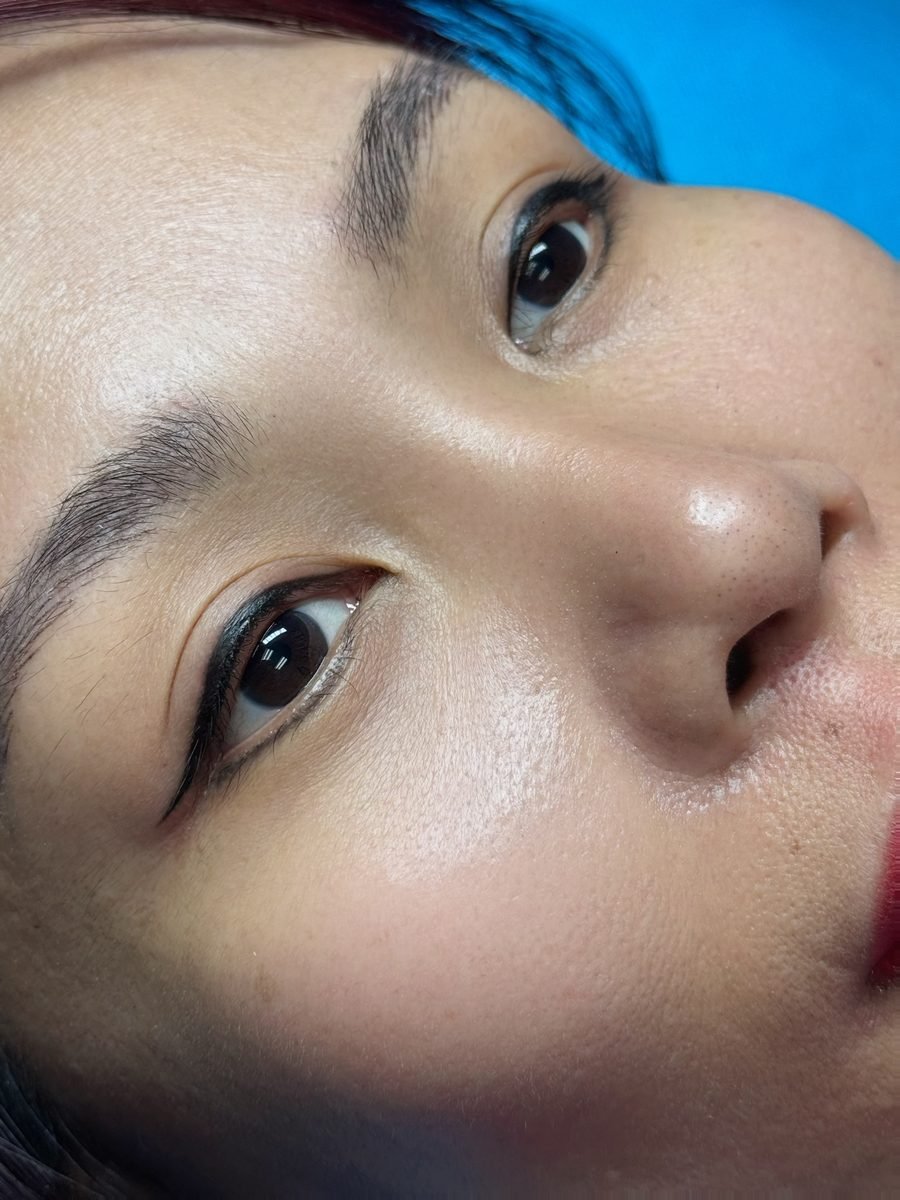 Permanent eyeliner with a small wing on a client