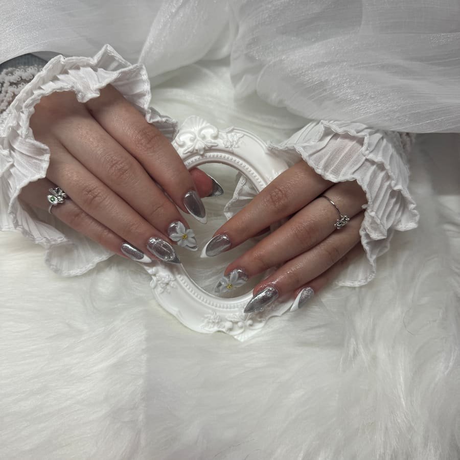Silver chrome almond nails with 3D accents